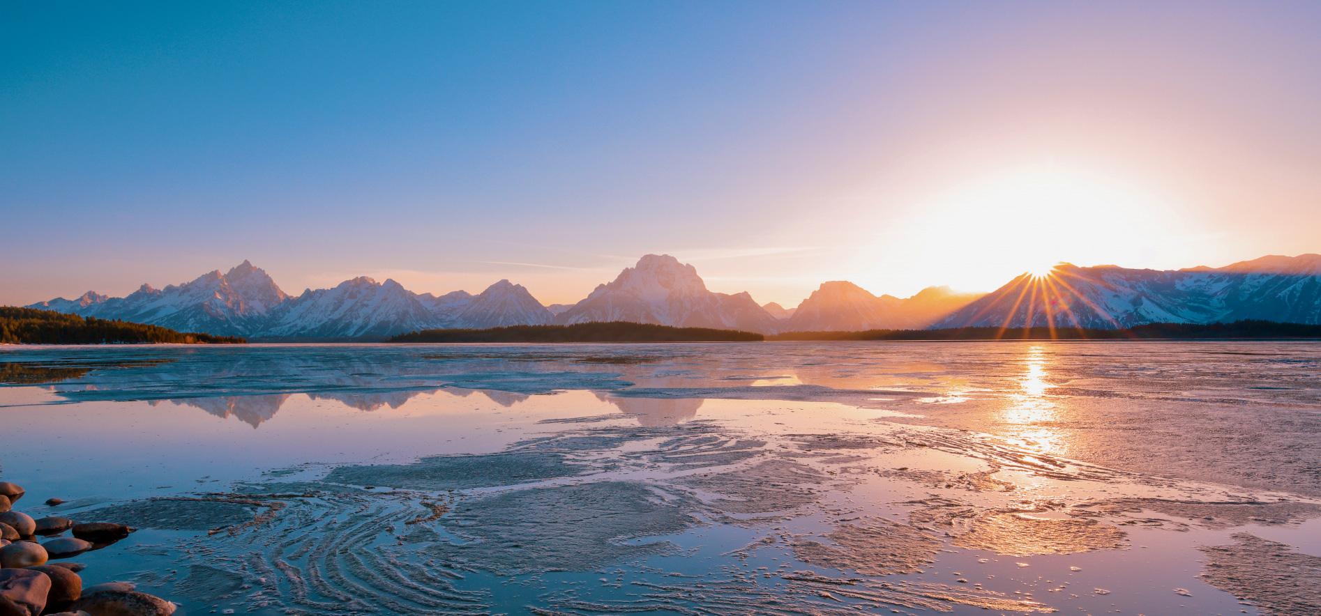 Icy mountain lake at sunrise