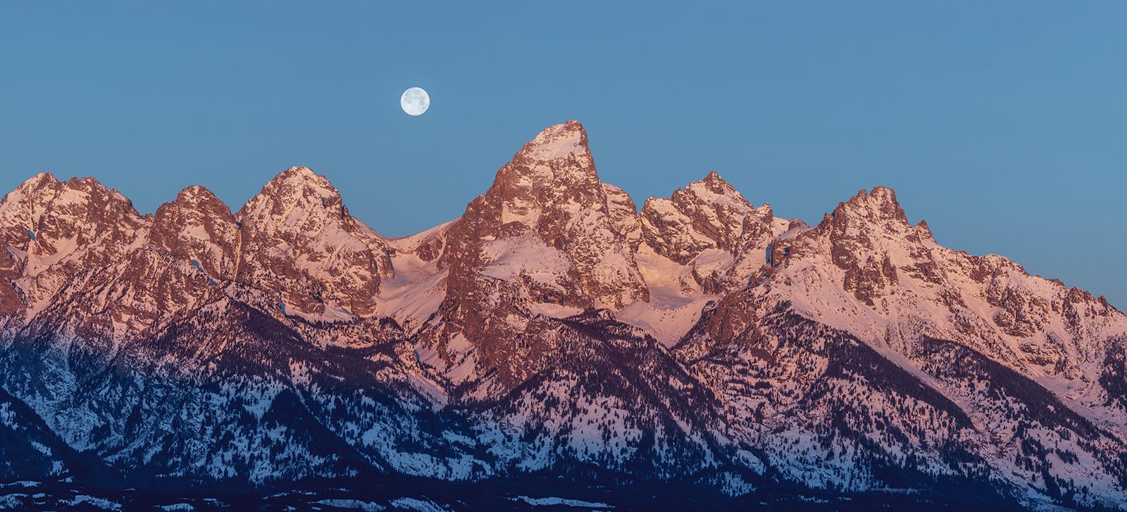 Jagged peaks with rising moon